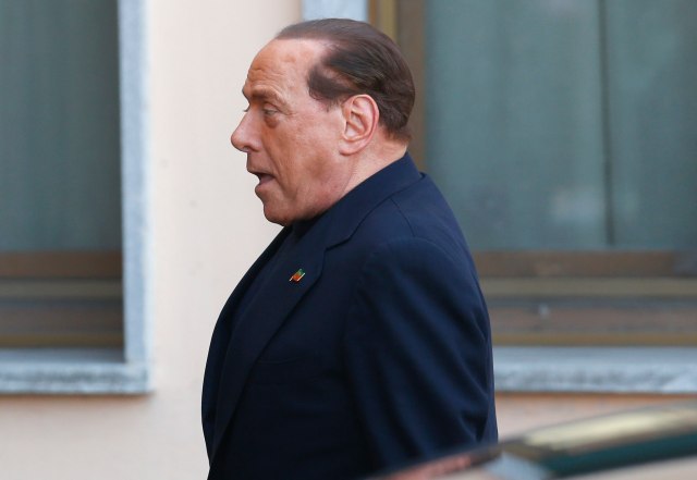 Former Italian PM Berlusconi looks on as he arrives to the Sacred Family Foundation in Cesano Boscone