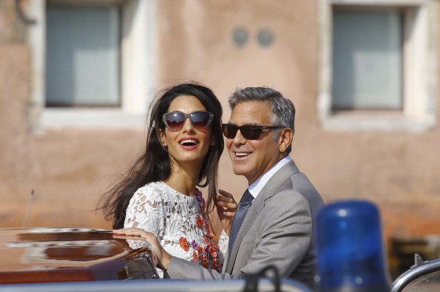 U.S. actor Clooney and his wife Alamuddin stand in a water taxi on the Grand Canal in Venice