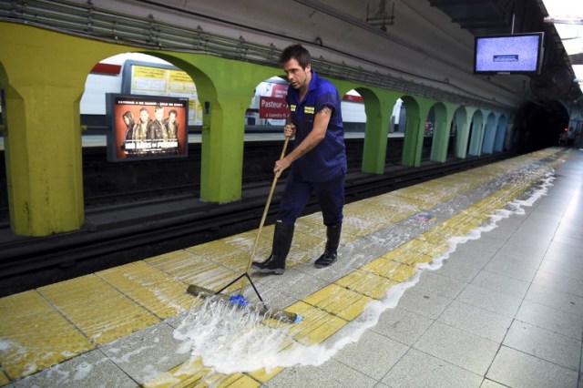 Argentine writer Enrique "Kike" Ferrari mops the floor of a subway station in Buenos Aires, Argentina, on March 14, 2016. Ferrari is an award-winning writer who makes his living cleaning a metro station in Argentina. His noir novels were translated into four languages in six countries, and received awards in Spain and Cuba. AFP PHOTO/EITAN ABRAMOVICH / AFP / EITAN ABRAMOVICH