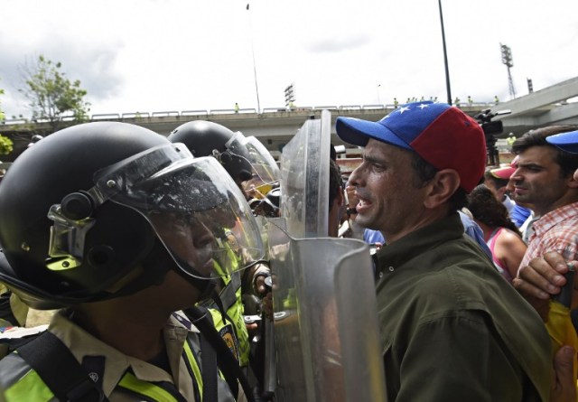 Miranda state Governor Henrique Capriles argues with police as he leads an opposition march attempting to reach the National Electoral Court in Caracas to demand validation of the signatures to initiate a recall referendum against President Nicolas Maduro, on June 7, 2016. / AFP PHOTO / JUAN BARRETO