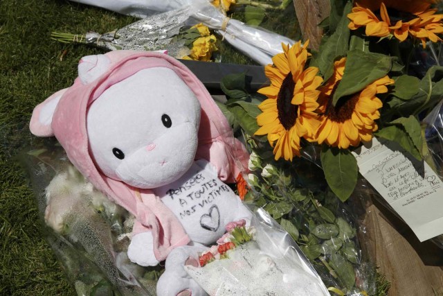 A child's stuffed toy with the message, "Thoughts to All the Victims" is seen as people pay tribute near the scene where a truck ran into a crowd at high speed killing scores and injuring more who were celebrating the Bastille Day national holiday, in Nice, France, July 15, 2016. REUTERS/Pascal Rossignol