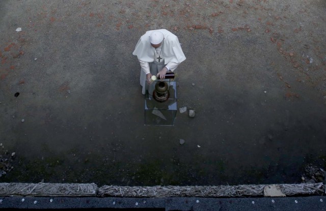 Pope Francis pays respects by the death wall in the former Nazi German concentration and extermination camp Auschwitz-Birkenau in Oswiecim, Poland, July 29, 2016. REUTERS/David W Cerny