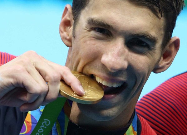 2016 Rio Olympics - Swimming - Victory Ceremony - Men's 4 x 200m Freestyle Relay Victory Ceremony - Olympic Aquatics Stadium - Rio de Janeiro, Brazil - 09/08/2016. Michael Phelps (USA) of USA poses with his gold medal.    REUTERS/Marcos Brindicci  FOR EDITORIAL USE ONLY. NOT FOR SALE FOR MARKETING OR ADVERTISING CAMPAIGNS.