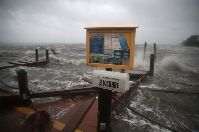 COCOA BEACH, FL - OCTOBER 07: Heavy waves caused by Hurricane Matthew pound the boat docks at the Sunset Bar and Grill, October 7, 2016 on Cocoa Beach, Florida. Hurricane Matthew passed by offshore as a catagory 3 hurricane bringing heavy winds and minor flooding.   Mark Wilson/Getty Images/AFP
