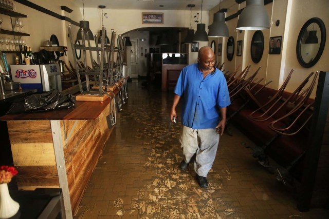 ST AUGUSTINE, FL - OCTOBER 08: Eugene Scott walks through the muck on the floor of Athena Restaurant after it was flooded by water as Hurricane Matthew passed through the area on October 8, 2016 in St Augustine, Florida. Across the Southeast, cver 1.4 million people have lost power due to Hurricane Matthew which has been downgraded to a category 1 hurricane on Saturday morning. Joe Raedle/Getty Images/AFP