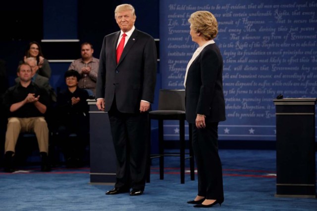 Republican U.S. presidential nominee Donald Trump and Democratic U.S. presidential nominee Hillary Clinton appear together during their presidential town hall debate at Washington University in St. Louis, Missouri, U.S., October 9, 2016.   REUTERS/Mike Segar