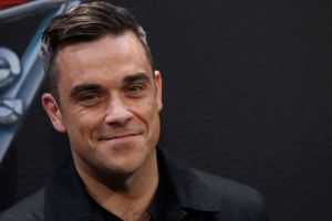 ¡Qué descaro! Robbie Williams se limpia luego de tocar las manos de un fan (Video)