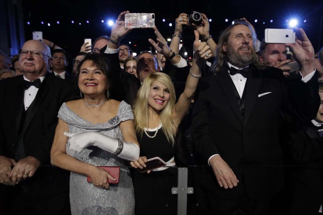 People listen to President Donald Trump at the Freedom Ball, Friday, Jan. 20, 2017, in Washington. (AP Photo/Evan Vucci)