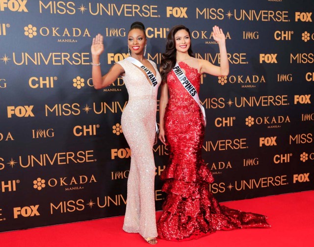 Miss Universe candidates Guyana Soyini Fraser of Guyana and Maxine Medinage of Philippines gesture for a picture during a red carpet inside a SMX convention in metro Manila, Philippines January 29, 2017. REUTERS/Romeo Ranoco