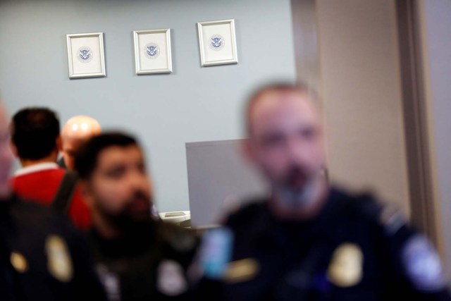 Picture frames, which formerly held portraits of officials including the President of the United States, hang empty with only a Department of Homeland Security seal in the U.S. Customs and Border Protection office during the travel ban at Los Angeles International Airport (LAX) in Los Angeles, California, U.S., January 28, 2017. REUTERS/Patrick T. Fallon
