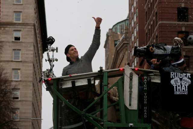 New England Patriots quarterback Tom Brady gives a thumbs up to fans during the team's victory parade through the streets of Boston after winning Super Bowl LI, in Boston
