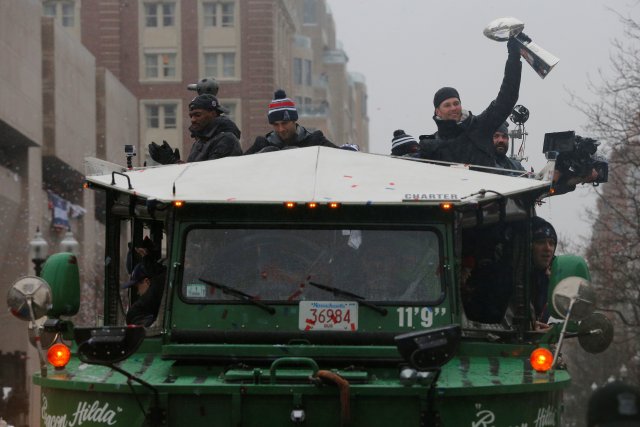 New England Patriots quarterback Tom Brady holds up one of the team's five Vince Lombardi trophies during their victory parade through the streets of Boston after winning Super Bowl LI, in Boston