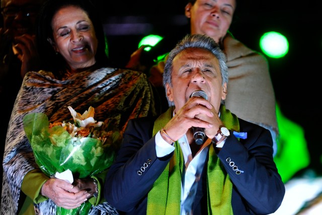 The Ecuadorean presidential candidate of the ruling Alianza PAIS party, Lenin Moreno, next to his wife Rocio Gonzalez (L), gives a speech to his supporters while waiting for the final results of the runoff election, in Quito on April 2, 2017. / AFP PHOTO / JUAN RUIZ