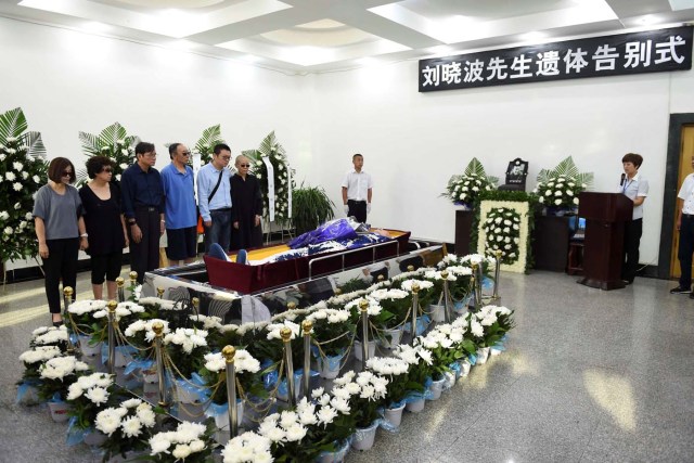 Liu Xia, wife of deceased Chinese Nobel Peace Prize-winning dissident Liu Xiaobo, and other relatives stand next to his coffin during his funeral in Shenyang, China in this photo released by Shenyang Municipal Information Office on July 15, 2017. Shenyang Municipal Information Office/via REUTERS. ATTENTION EDITORS - THIS IMAGE WAS PROVIDED BY A THIRD PARTY. NO RESALES. NO ARCHIVES.