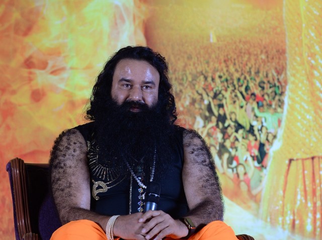 (FILES) This file photo taken on September 8, 2015 shows Indian chief of the religious sect Dera Sacha Sauda (DSS) Gurmeet Ram Rahim Singh at a news conference to launch the score for his film 'MSG-2 The Messenger' in Mumbai. Troops lined the streets of a city in north India on August 25, 2017 after tens of thousands of distraught devotees of an Indian sect leader dubbed the "guru in bling" headed there to await a verdict in his rape trial.  / AFP PHOTO / PUNIT PARANJPE