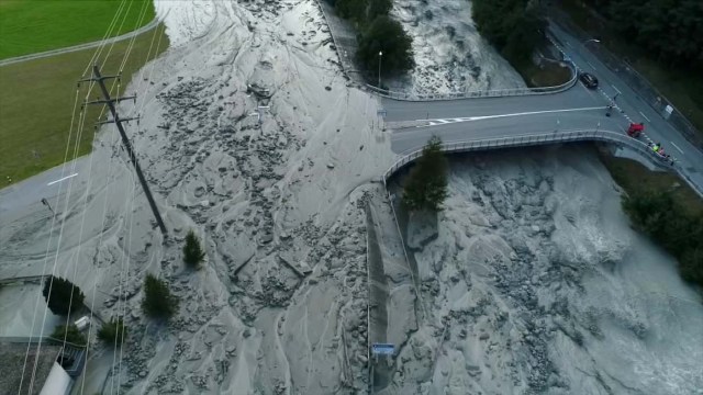 Still image taken from video shows mud and stones blocking a road in the remote village of Bondo in Switzerland, August 23, 2017 after a landslide struck it. REUTERS/LOCAL TEAM via Reuters TV NO ACCESS IT WEBSITES ITALY OUT SWITZERLAND OUT