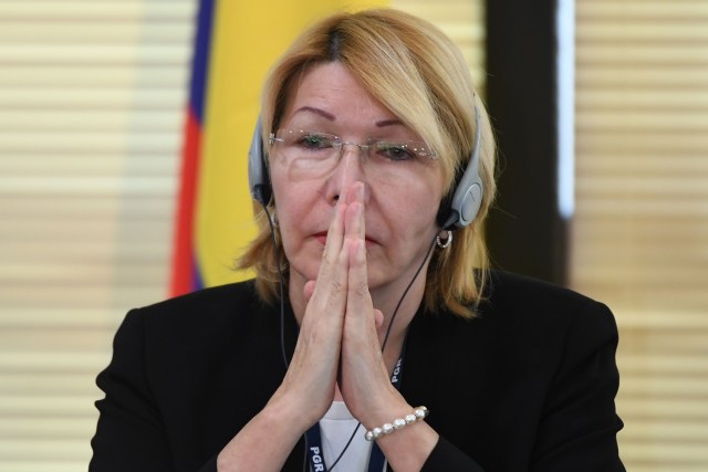 Venezuela's fugitive former top prosecutor Luisa Ortega, one of President Nicolas Maduro's most vocal critics, invited by Brazil's prosecutor general Rodrigo Janot, attends a conference with representatives from the Latin American regional trading alliance Mercosur, in Brasilia, on August 23, 2017. Ortega promised to use the international forum in Brazil to intensify corruption allegations against Maduro, who called for her arrest. Days after a dramatic escape from Venezuela, Ortega arrived in Brasilia promising to dish dirt on Maduro, who in turn asked Interpol to put out a "red notice" warrant for his critic.  / AFP PHOTO / EVARISTO SA