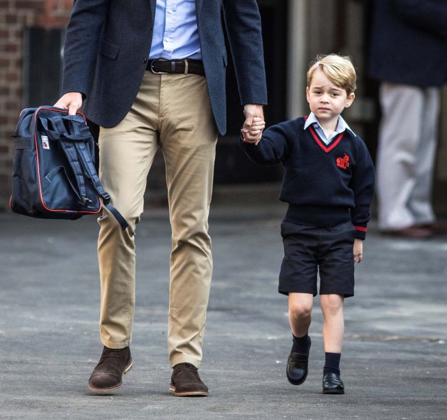 Prince George holds his father Britain's Prince William's hand as he arrives on his first day of school at Thomas's school in Battersea, London, September 7, 2017. REUTERS/Richard Pohle/Pool