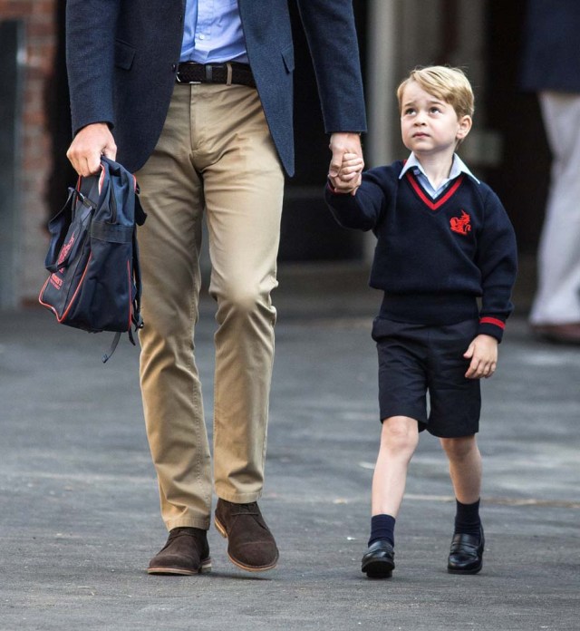 Prince George holds his father Britain's Prince William's hand as he arrives on his first day of school at Thomas's school in Battersea, London, September 7, 2017. REUTERS/Richard Pohle/Pool