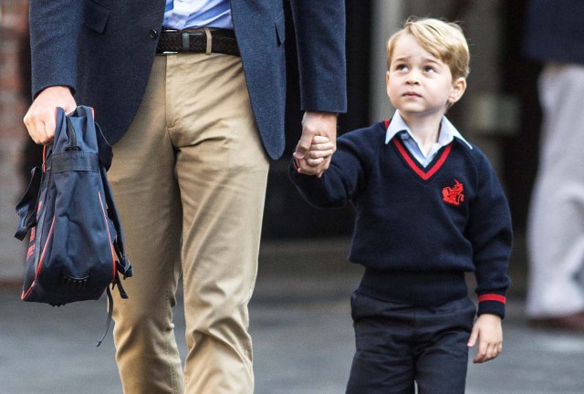 Prince George holds his father Britain's Prince William's hand as he arrives on his first day of school at Thomas's school in Battersea, London, September 7, 2017. REUTERS/Richard Pohle/Pool