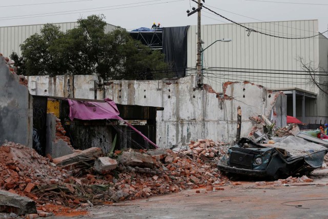 A damaged wall and a smashed vehicle are pictured after an earthquake in Mexico City, Mexico September 8, 2017. REUTERS/Carlos Jasso