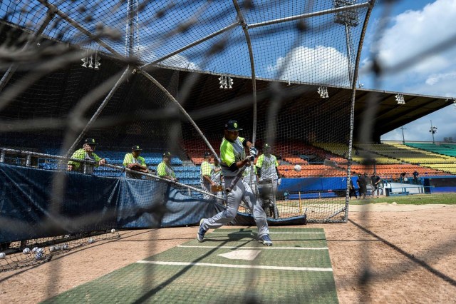 Players of the Venezuelan baseball team Leones del Caracas attend a training session at the Universitario stadium in Caracas, on September 18, 2017. While baseball is Venezuela's national sport, some fans are angry that the government, given the severity of the economic crisis and the political tension, will spend nearly ten million dollars on organizing the upcoming Winter League rather than on imports of food and medicine. / AFP PHOTO / FEDERICO PARRA