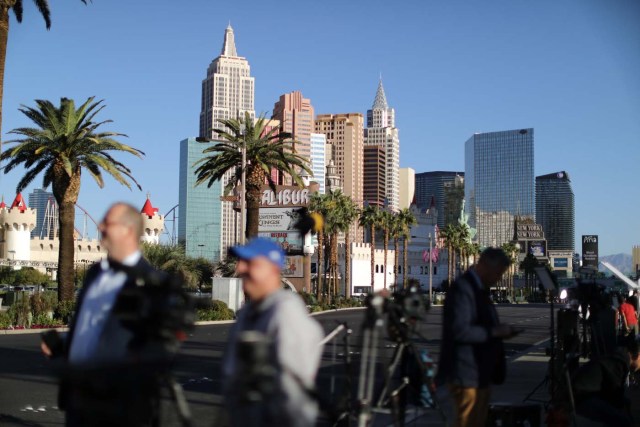 News crews stand in front of the closed Las Vegas Strip next to the site of the Route 91 music festival mass shooting outside the Mandalay Bay Resort and Casino in Las Vegas, Nevada, U.S., October 3, 2017. REUTERS/Lucy Nicholson