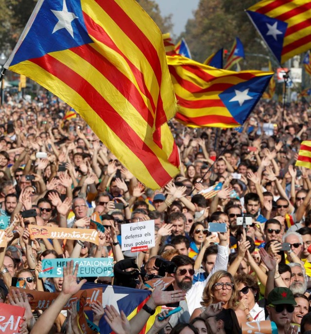 People react as they watch on giant screens a plenary session outside the Catalan regional parliament in Barcelona, Spain, October 27, 2017. REUTERS/Yves Herman