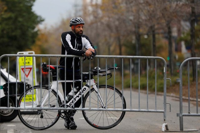 Misha Thomas, who said he rode from Harlem to pay his respects for victims of Tuesday's attack, stands outside a police barricade on the bike path next to West Street a day after a man driving a rented pickup truck mowed down pedestrians and cyclists on a bike path alongside the Hudson River in New York City, in New York, U.S. November 1, 2017. REUTERS/Shannon Stapleton