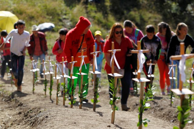 People pay tribute on the first anniversary of the plane crash where several players of the Chapecoense soccer team died, in La Union, Colombia November 28, 2017. REUTERS/Fredy Builes