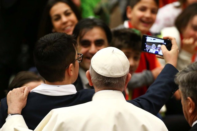 A boy takes a selfie with Pope Francis during a special audience for a delegation of donors of the Christmas tree and the nativity scene set up in Saint Peter's square at the Vatican, December 7, 2017. REUTERS/Alessandro Bianchi