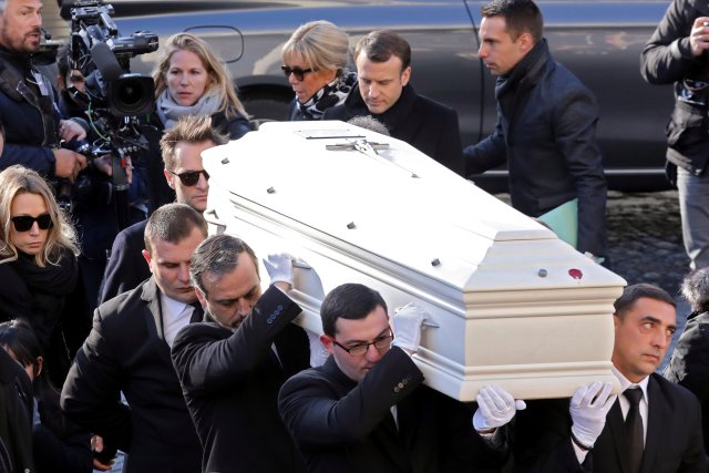 Daughter of late French singer Johnny Hallyday, Laura Smet (L), his son David Hallyday (2ndL), French President Emmanuel Macron (Top C) and his wife Brigitte walk by the coffin outside the Madeleine Church at the start of the funeral ceremony for the late singer and actor in Paris, France, December 9, 2017. REUTERS/Ludovic Marin/Pool