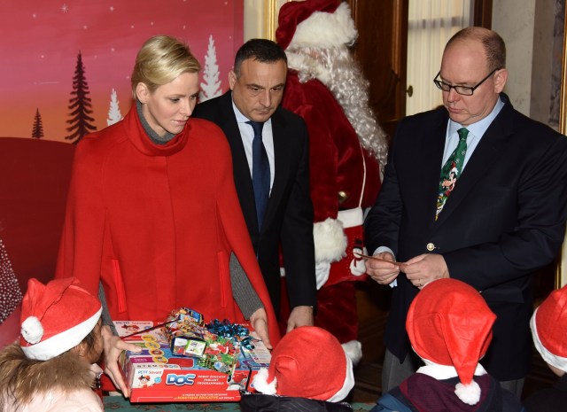 Prince Albert II of Monaco and his wife Princess Charlene of Monaco give presents to Monaco's children during the traditional Christmas tree ceremony at the Monaco Palace as part of Christmas holiday season in Monaco, December 20, 2017. REUTERS/Jean-Pierre Amet