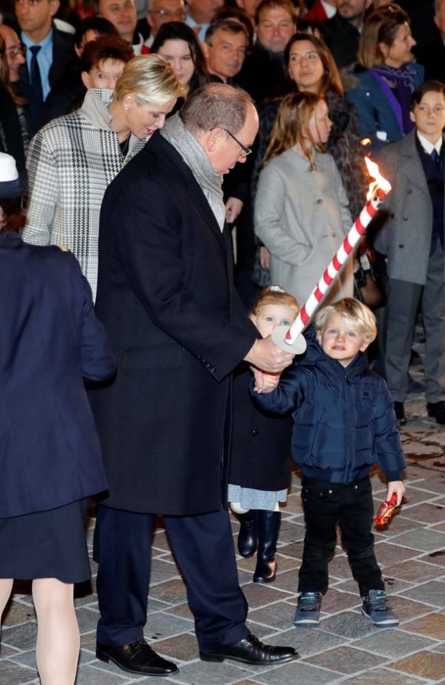 Prince Albert II of Monaco,Princess Charlene and their twins Prince Jacques and Princess Gabriella hold a torch to burn a small fisherman's boat during the traditional Sainte Devote celebration in Monaco, January 26, 2018. REUTERS/Eric Gaillard
