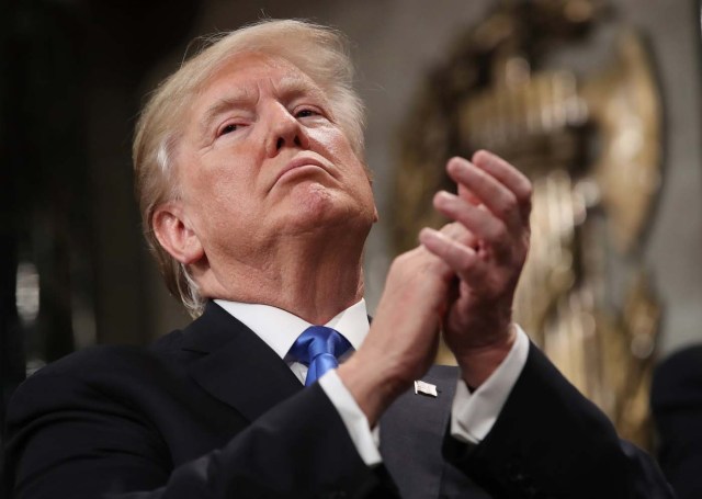 U.S. President Donald Trump applauds during his first State of the Union address to a joint session of Congress inside the House Chamber on Capitol Hill in Washington, U.S., January 30, 2018. REUTERS/Win McNamee/Pool
