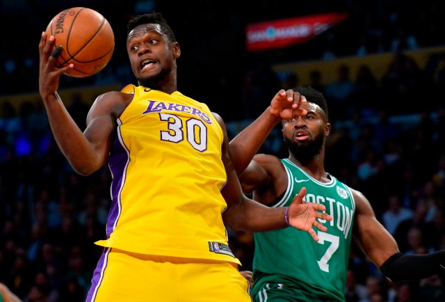 January 23, 2018; Los Angeles, CA, USA; Los Angeles Lakers forward Julius Randle (30) grabs a rebound in front of Boston Celtics guard Jaylen Brown (7) during the second half at Staples Center. Mandatory Credit: Gary A. Vasquez-USA TODAY Sports