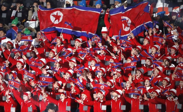 Pyeongchang 2018 Winter Olympics – Opening ceremony – Pyeongchang Olympic Stadium - Pyeongchang, South Korea – February 9, 2018 - Cheerleaders of North Korea wave their national flags as they wait the start of the opening ceremony. REUTERS/Kim Kyung-Hoon