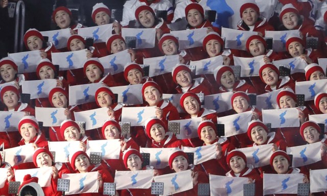 Pyeongchang 2018 Winter Olympics – Opening ceremony – Pyeongchang Olympic Stadium - Pyeongchang, South Korea – February 9, 2018 - Cheerleaders of North Korea hold unification flags as they wait the start of the opening ceremony. REUTERS/Kim Kyung-Hoon