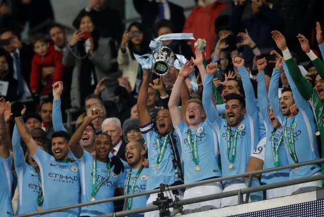 Soccer Football - Carabao Cup Final - Arsenal vs Manchester City - Wembley Stadium, London, Britain - February 25, 2018   Manchester City’s Vincent Kompany lifts the trophy as they celebrate winning the Carabao Cup   Action Images via Reuters/Carl Recine     EDITORIAL USE ONLY. No use with unauthorized audio, video, data, fixture lists, club/league logos or "live" services. Online in-match use limited to 75 images, no video emulation. No use in betting, games or single club/league/player publications. Please contact your account representative for further details.