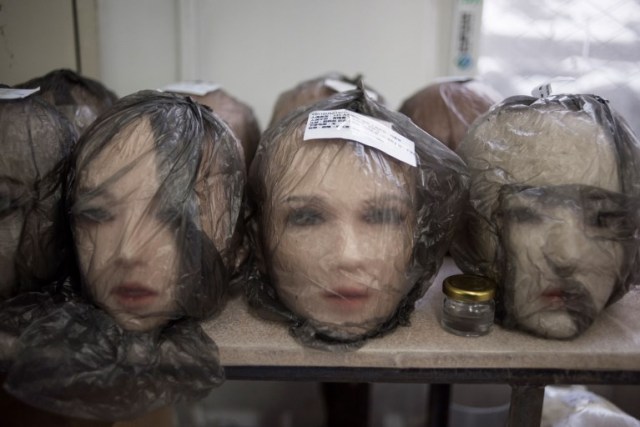 This photo taken on February 1, 2018 shows non-robotic silicone doll heads at a doll factory of EXDOLL, a firm based in the northeastern Chinese port city of Dalian. With China facing a massive gender gap and a greying population, a company wants to hook up lonely men and retirees with a new kind of companion: "Smart" sex dolls that can talk, play music and turn on dishwashers. / AFP PHOTO / FRED DUFOUR / TO GO WITH China-sex-lifestyle, FOCUS by Joanna CHIU