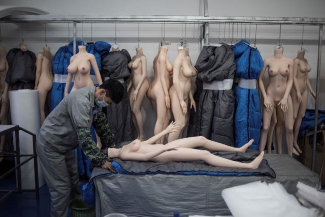 EDITORS NOTE: Graphic content / This photo taken on February 1, 2018 shows a worker preparing a silicone doll at a factory of EXDOLL, a firm based in the northeastern Chinese port city of Dalian. With China facing a massive gender gap and a greying population, a company wants to hook up lonely men and retirees with a new kind of companion: "Smart" sex dolls that can talk, play music and turn on dishwashers. / AFP PHOTO / FRED DUFOUR / TO GO WITH China-sex-lifestyle, FOCUS by Joanna CHIU