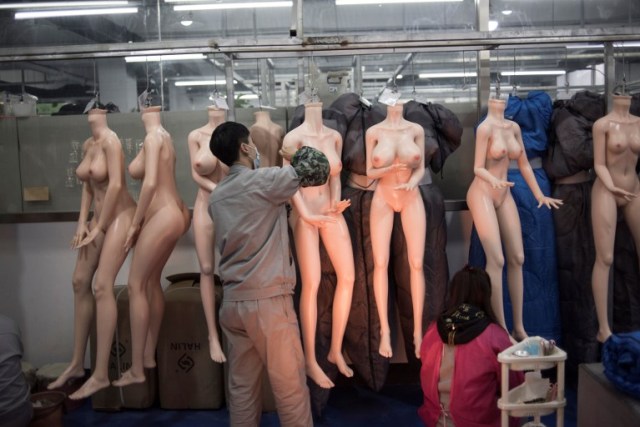 EDITORS NOTE: Graphic content / This photo taken on February 1, 2018 shows a worker preparing silicone dolls at a factory of EXDOLL, a firm based in the northeastern Chinese port city of Dalian. With China facing a massive gender gap and a greying population, a company wants to hook up lonely men and retirees with a new kind of companion: "Smart" sex dolls that can talk, play music and turn on dishwashers. / AFP PHOTO / FRED DUFOUR / TO GO WITH China-sex-lifestyle, FOCUS by Joanna CHIU