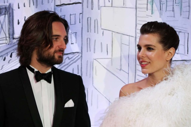Charlotte Casiraghi (R) and her partner Dimitri Rassam (L) pose upon their arrival for the annual Rose Ball at the Monte-Carlo Sporting Club in Monaco, on March 24, 2018. The Rose Ball is one of the major charity events in Monaco. Created in 1954, it benefits the Princess Grace Foundation. / AFP PHOTO / POOL / VALERY HACHE