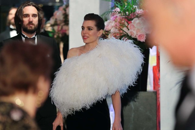Charlotte Casiraghi (C) and her partner Dimitri Rassam arrive for the annual Rose Ball at the Monte-Carlo Sporting Club in Monaco, on March 24, 2018. The Rose Ball is one of the major charity events in Monaco. Created in 1954, it benefits the Princess Grace Foundation. / AFP PHOTO / POOL / VALERY HACHE