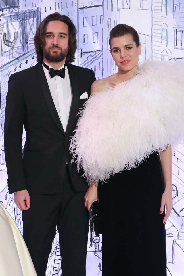 Charlotte Casiraghi (R) and her partner Dimitri Rassam (L) pose upon their arrival for the annual Rose Ball at the Monte-Carlo Sporting Club in Monaco, on March 24, 2018. The Rose Ball is one of the major charity events in Monaco. Created in 1954, it benefits the Princess Grace Foundation. / AFP PHOTO / POOL / VALERY HACHE