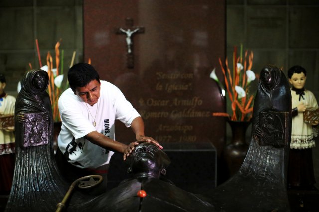 FILE PHOTO: A man prays as he waits for the newly elevated Cardinal Gregorio Rosa Chavez  at the grave of Mons. Oscar Arnulfo Romero upon his return at the Metropolitan Cathedral in San Salvador, El Salvador, July 4, 2017. REUTERS/Jose Cabezas/File Photo