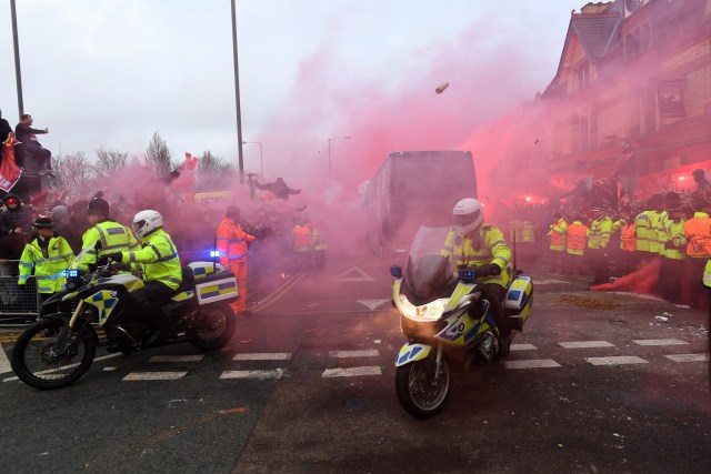 Bottles and cans are thrown at the bus as Manchester City players arrive at the stadium before the UEFA Champions League first leg quarter-final football match between Liverpool and Manchester City, at Anfield stadium in Liverpool, north west England on April 4, 2018. / AFP PHOTO / Paul ELLIS