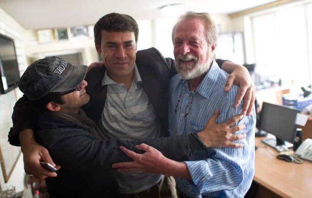 (FILES) In this file photo taken on April 17, 2012 Agence France-Presse (AFP) photographer Shah Marai (C) embraces colleagues Massoud Hossaini (L) and Lawrence Bartlett (R), after Hossain had won the Pulitzer Prize, at the AFP office in Kabul. Agence France-Presse's chief photographer in Kabul, Shah Marai, was killed April 30, AFP has confirmed, in a secondary explosion targeting a group of journalists who had rushed to the scene of a suicide blast in the Afghan capital. / AFP PHOTO / Johannes EISELE