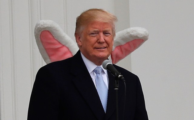 U.S. President Donald Trump appears on the South Portico of the White House with the Easter Bunny standing behind him as the annual White House Easter Egg Roll is held on the South Lawn of the White House in Washington, U.S., April 2, 2018. REUTERS/Carlos Barria