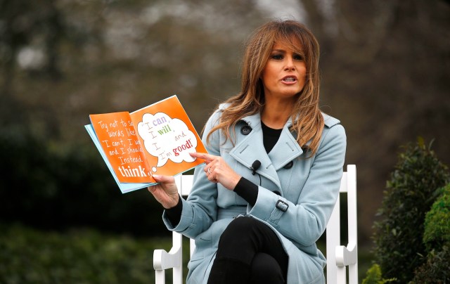 U.S. first lady Melania Trump reads a book to children gathered for the annual White House Easter Egg Roll on the South Lawn of the White House in Washington, U.S., April 2, 2018. REUTERS/Leah Millis